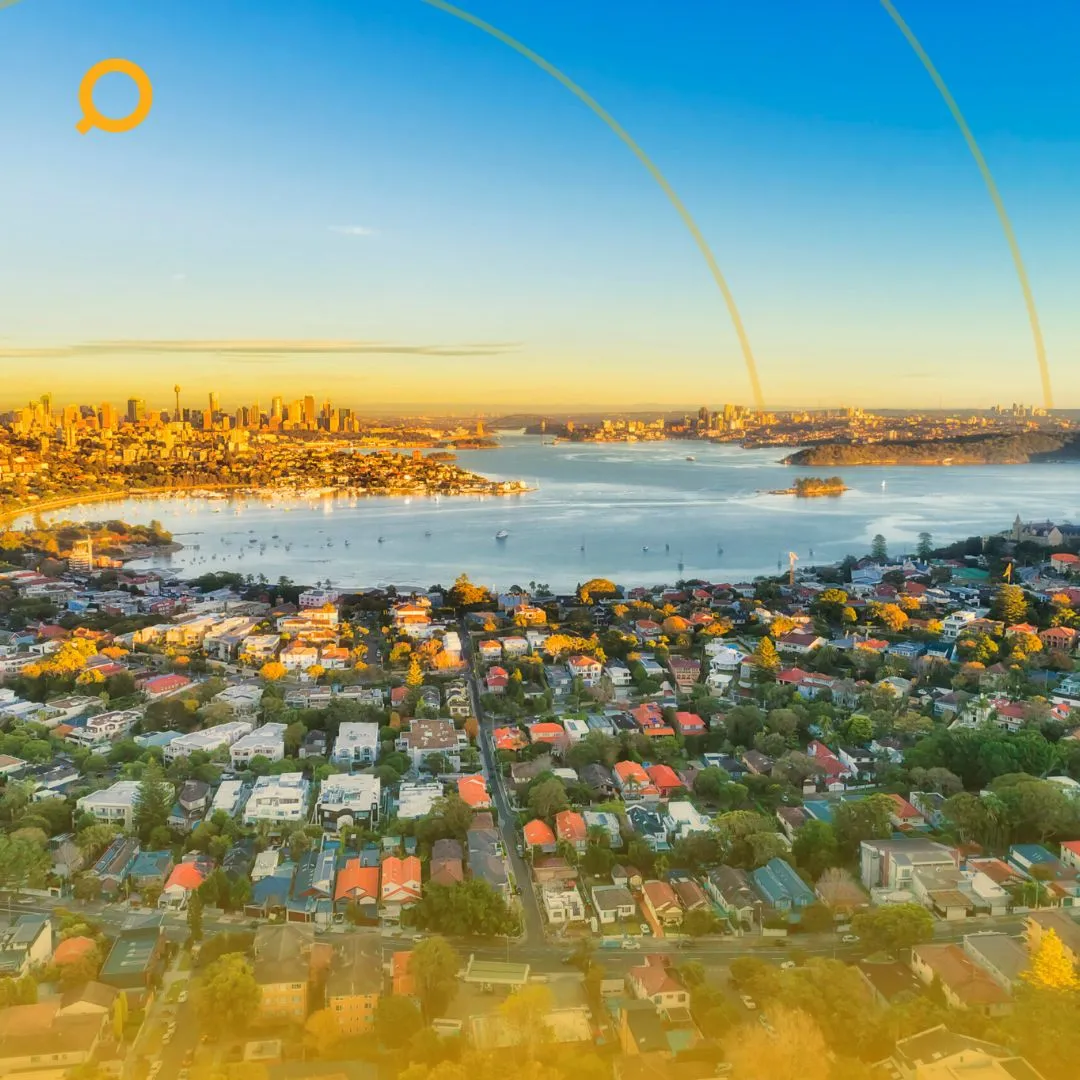 A skyview of property near a coast with Search property's logo on the upper right