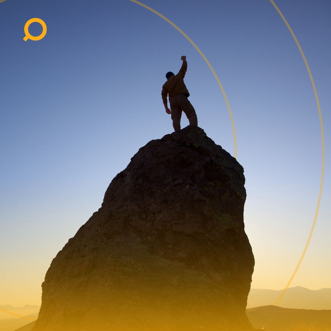 Man on top of a big rock