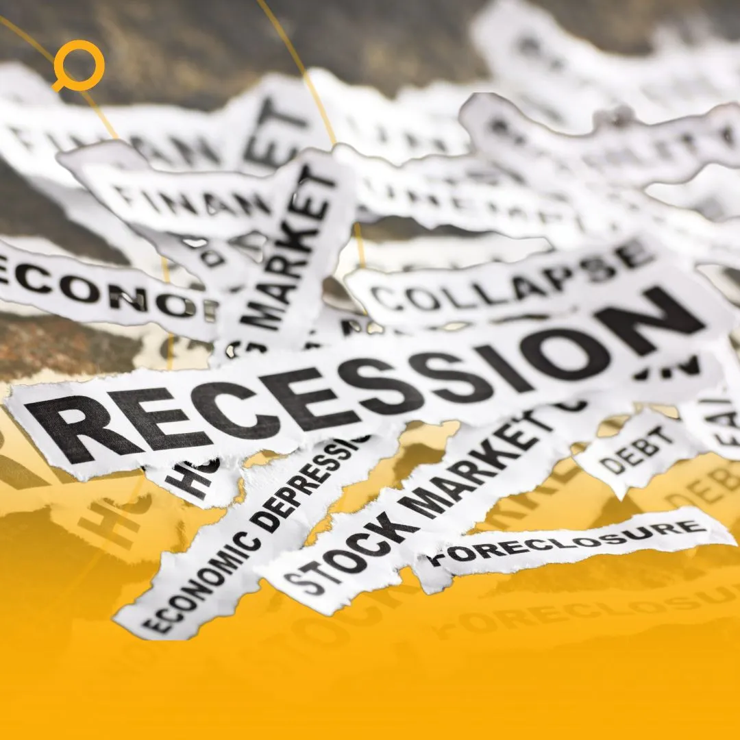 torn pieces of paper with words related to economic recession
