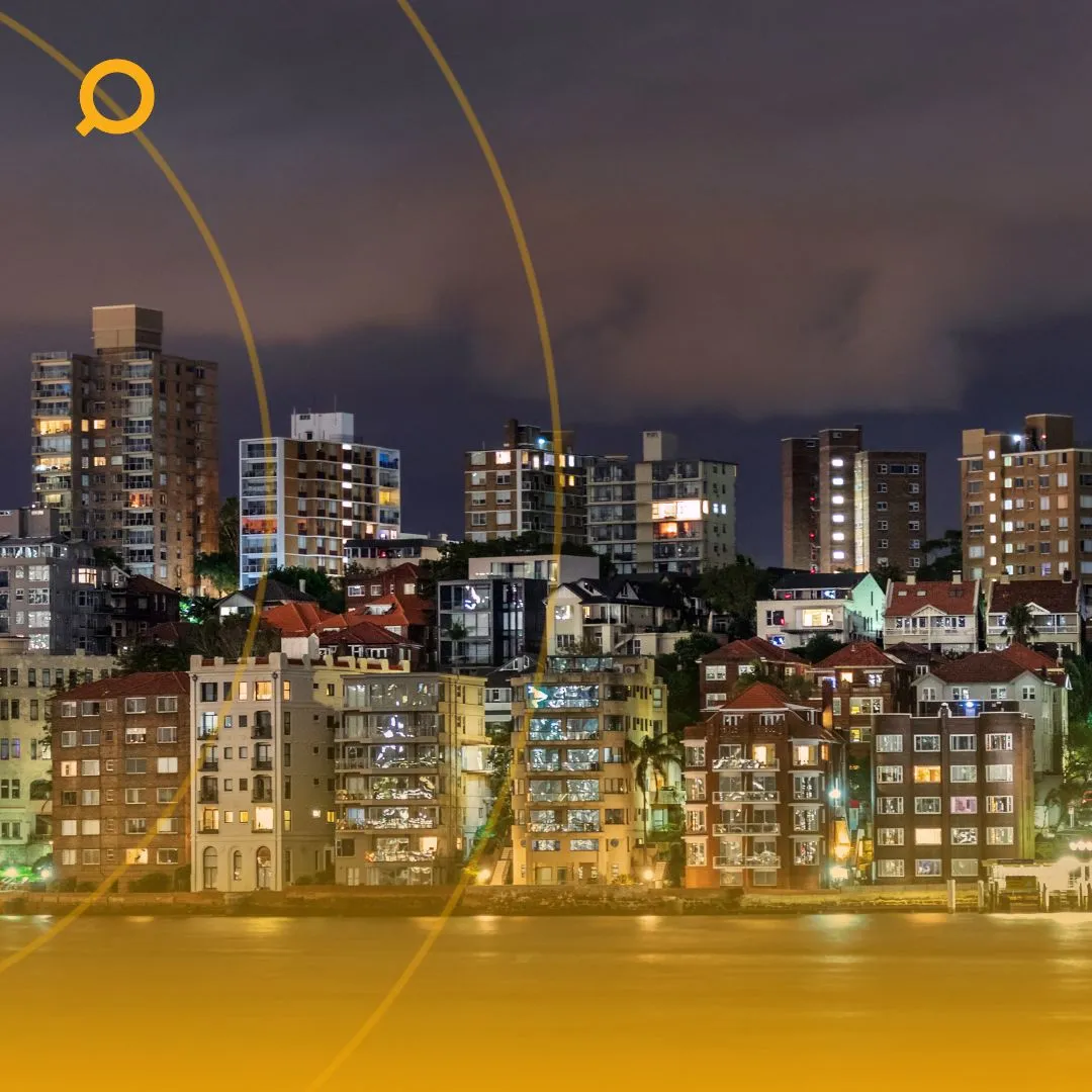 nighttime cityscape featuring illuminated residential and commercial buildings