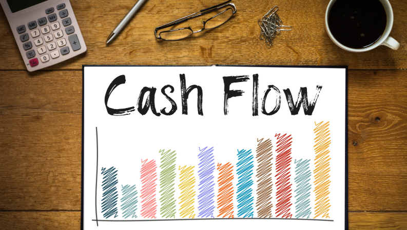 notepad displaying the words 'Cash Flow' above a colourful bar chart