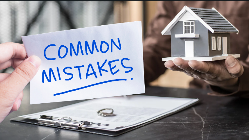small model house over a contract and keys, symbolising common real estate mistakes