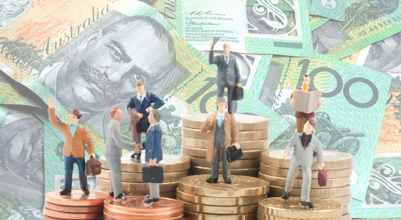 Miniature business figurines standing on stacks of coins, with Australian 100-dollar banknotes