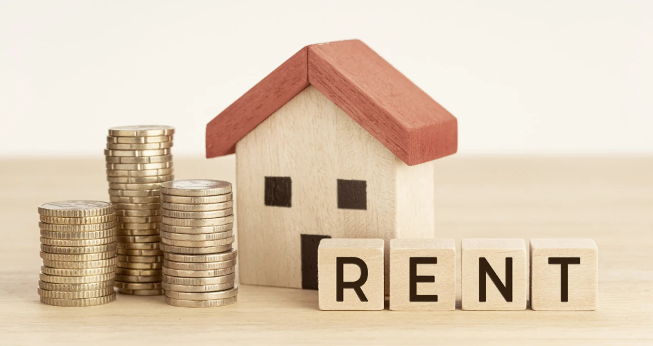 house with stacked coins, symbolising rental income