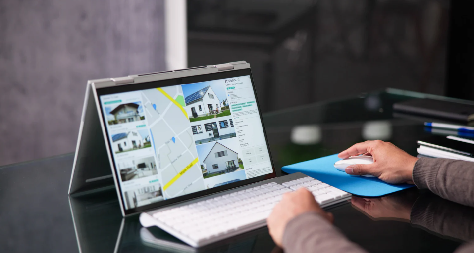  person searching for real estate listings in a tablet displaying property images