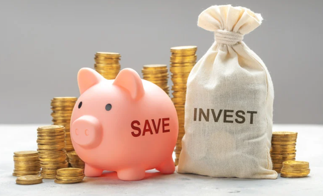 Piggy bank labeled 'SAVE' and a money bag labeled 'INVEST' with stacked coins.