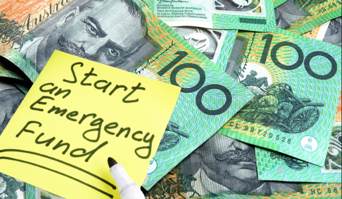 A sticky note reads "Start an Emergency Fund" on a background of Australian $100 banknotes.