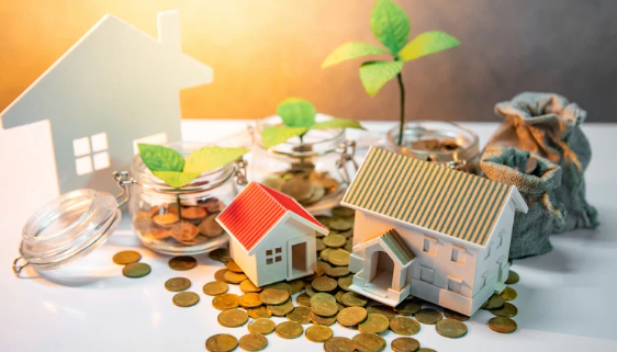 Model houses, coins, and jars with plants symbolizing real estate investment and financial growth.