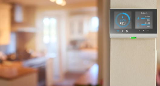 Smart energy monitor screen in a modern kitchen, displaying real-time electricity usage and cost savings in an energy-efficient home.