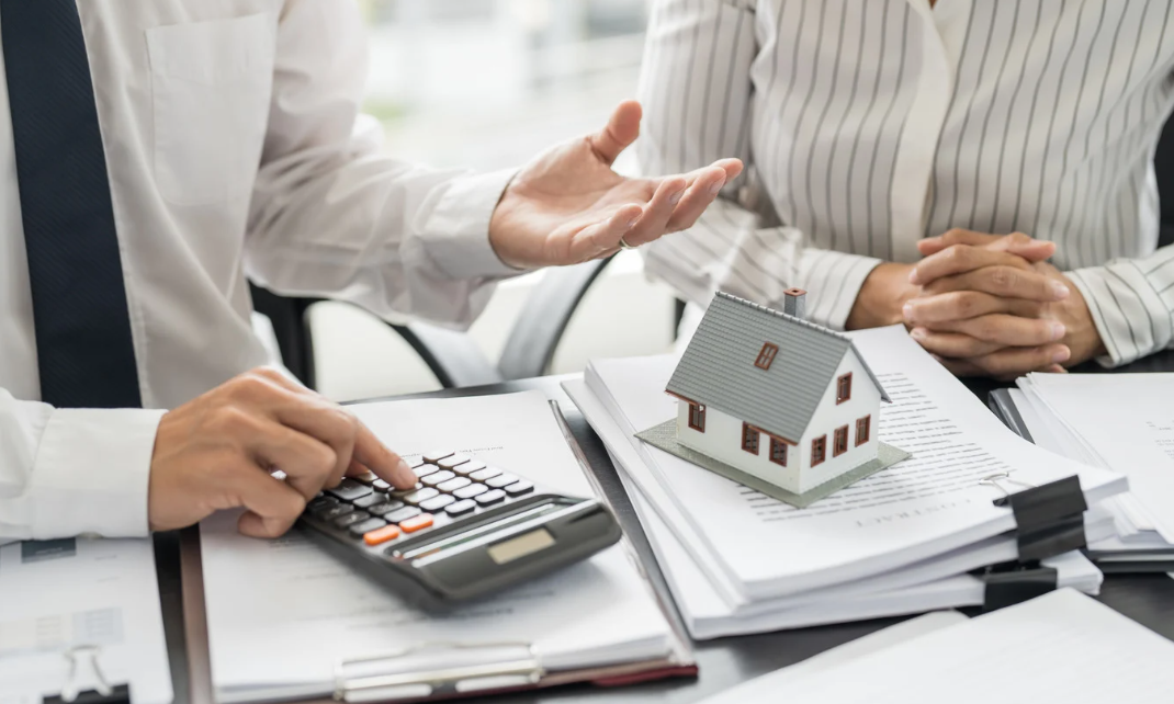 Two individuals strategising property investment