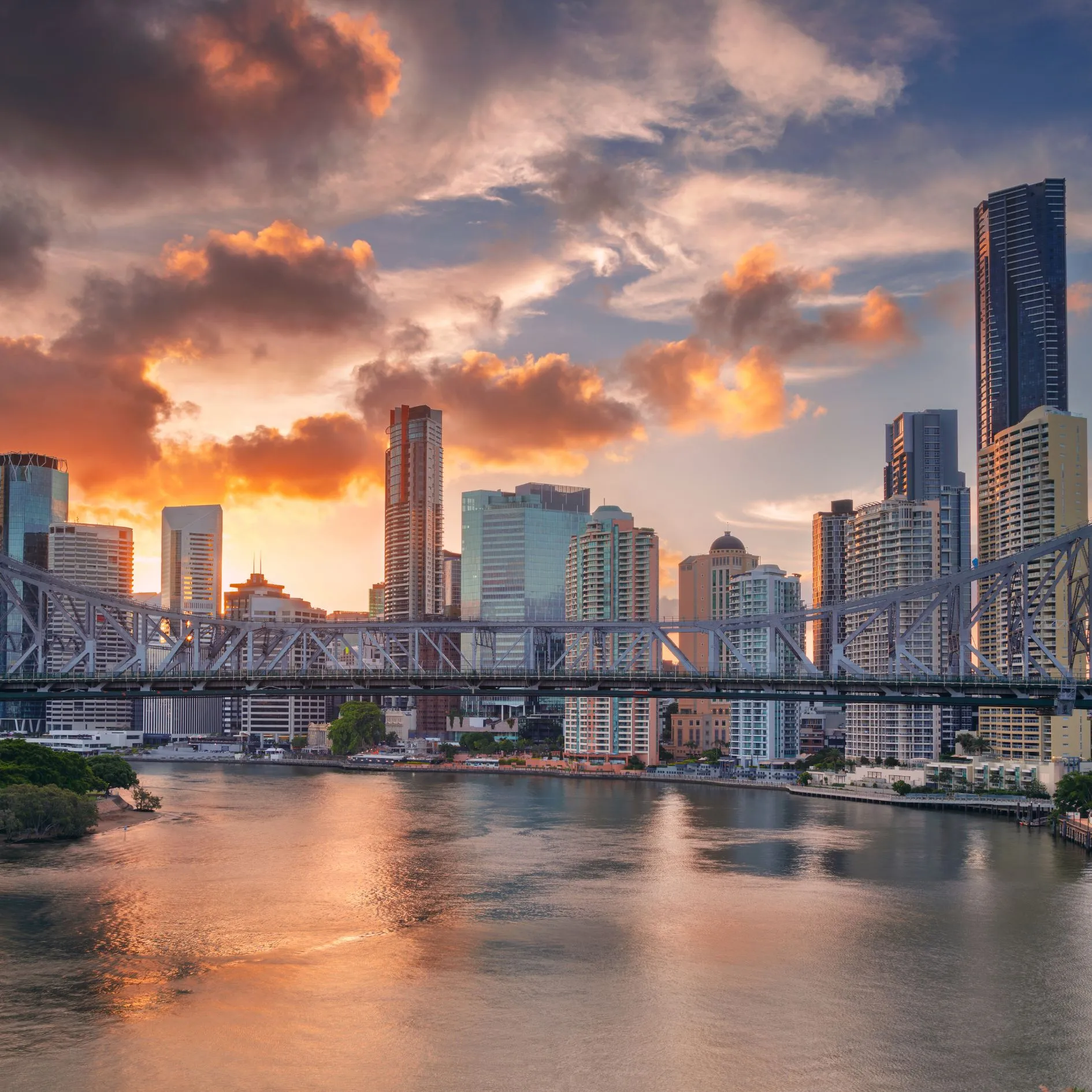 A city skyline with a bridge in the foreground.