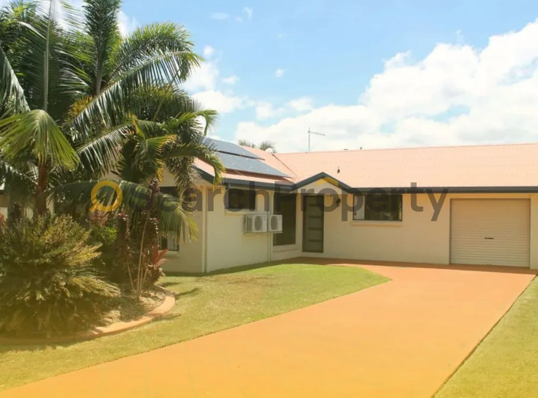 Single-storey suburban home with solar panels, air conditioning units, and a tropical garden, ideal representation of energy-efficient investment property in Queensland.