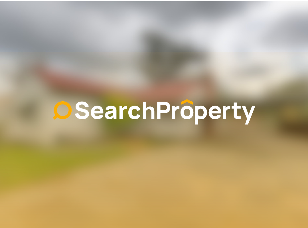 Spacious single-storey investment property with large paved driveway, carport, and landscaped yard under overcast sky