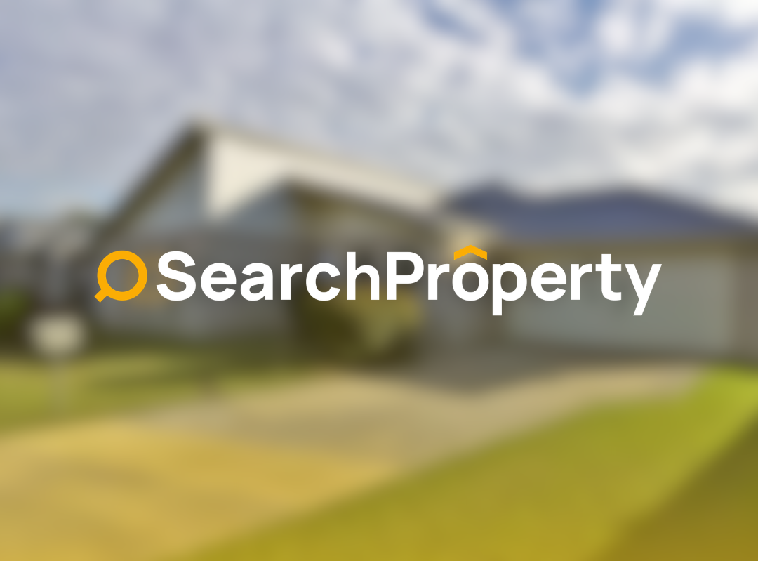 Modern beige house with large windows, landscaped garden with green shrubs and grassy yard, luxury home exterior under clear blue sky, residential property for sale.
